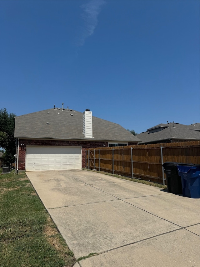 view of side of home with a yard and a garage