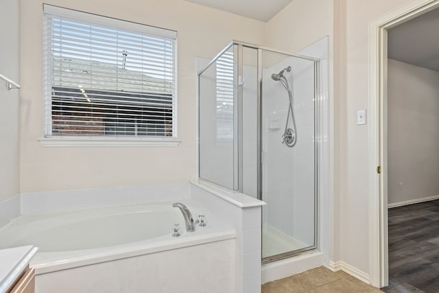 bathroom with plus walk in shower, wood-type flooring, and vanity