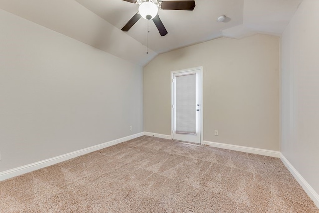 carpeted empty room featuring lofted ceiling and ceiling fan