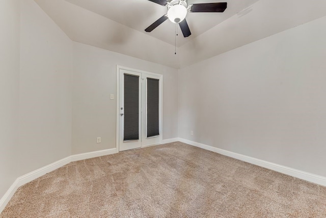 carpeted empty room with ceiling fan and vaulted ceiling