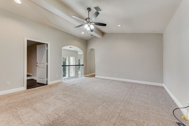 carpeted spare room with ceiling fan and lofted ceiling with beams