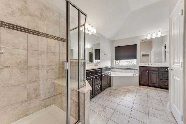 bathroom with separate shower and tub, vaulted ceiling, vanity, and tile patterned floors