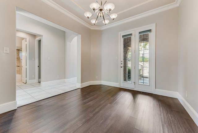 empty room with light wood-type flooring, a chandelier, and ornamental molding