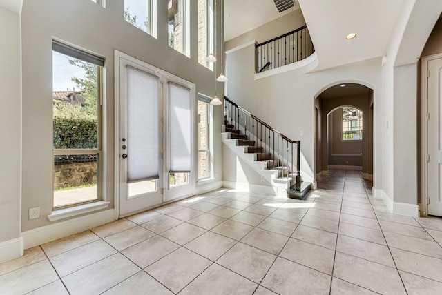 tiled entrance foyer featuring a high ceiling