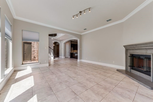 unfurnished living room featuring light tile patterned floors, crown molding, and a premium fireplace