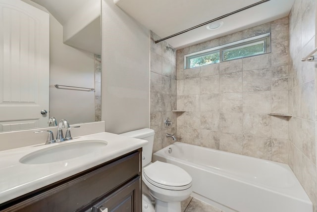 full bathroom featuring vanity, toilet, tile patterned floors, and tiled shower / bath