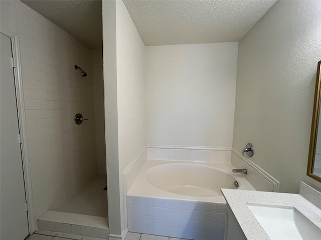 bathroom with vanity, a textured ceiling, tile patterned flooring, and shower with separate bathtub