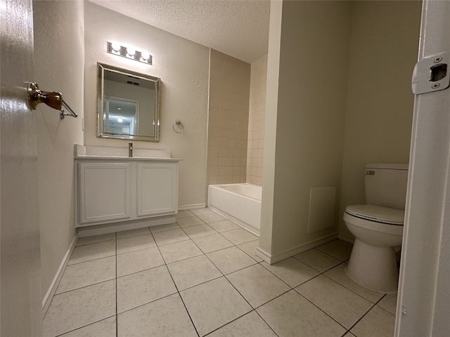 bathroom featuring a textured ceiling, vanity, toilet, and tile patterned flooring