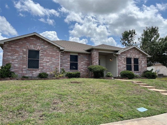 ranch-style home featuring cooling unit and a front yard