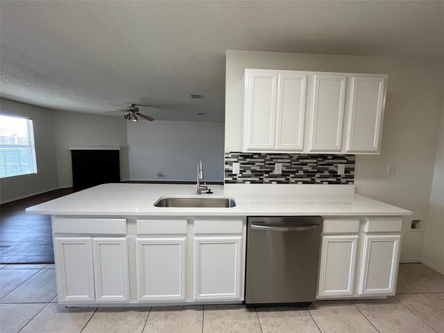 kitchen with stainless steel dishwasher, ceiling fan, sink, and white cabinetry