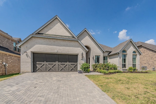 view of front of property with a front yard and a garage