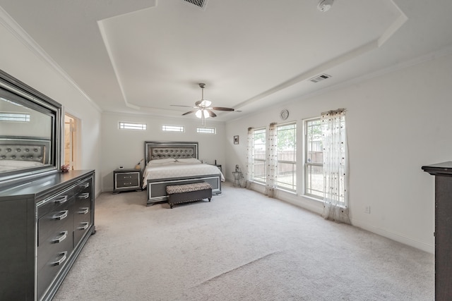 bedroom with carpet flooring, a tray ceiling, ceiling fan, and crown molding