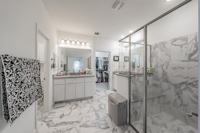 bathroom featuring vanity and a shower with shower door