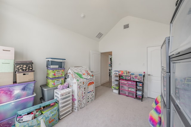 rec room featuring light carpet and vaulted ceiling