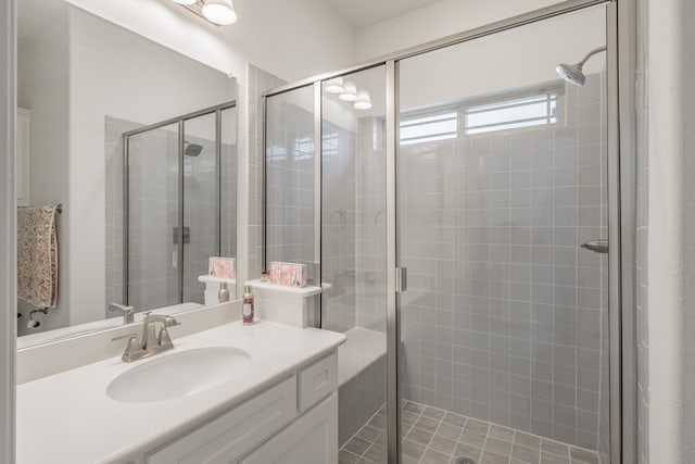 bathroom featuring vanity and a shower with door