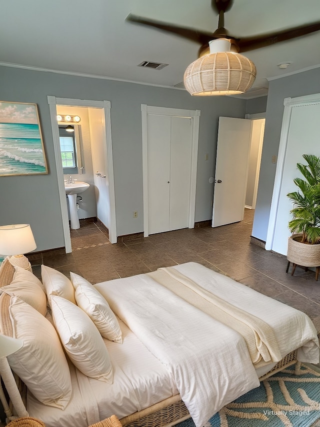 tiled bedroom with ensuite bathroom and ceiling fan