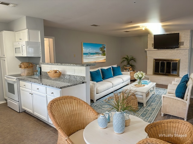 tiled living room with a fireplace