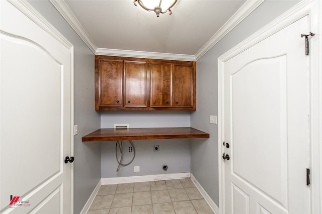 clothes washing area with light tile patterned floors, crown molding, hookup for an electric dryer, washer hookup, and cabinets