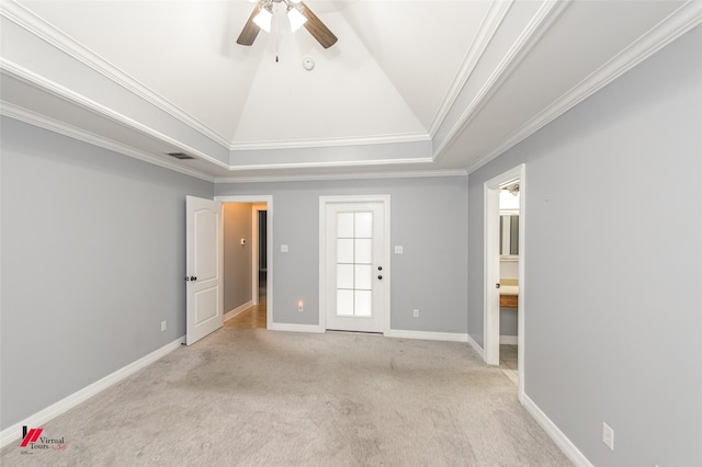 carpeted spare room with crown molding, a tray ceiling, and ceiling fan