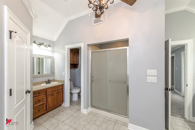 bathroom featuring a shower with door, vanity, toilet, ornamental molding, and lofted ceiling