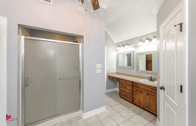 bathroom with vanity, crown molding, and a shower with shower door