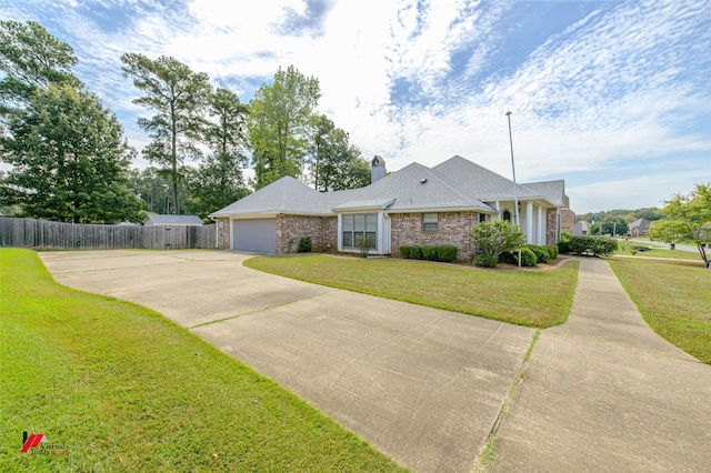 view of front facade featuring an attached garage, brick siding, fence, concrete driveway, and a front lawn