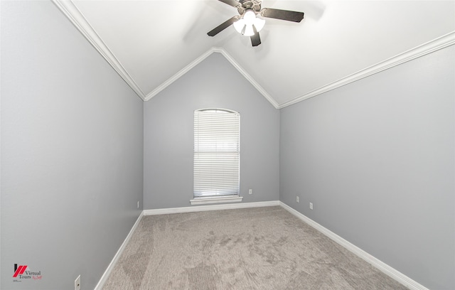 empty room with lofted ceiling, ceiling fan, light colored carpet, and ornamental molding