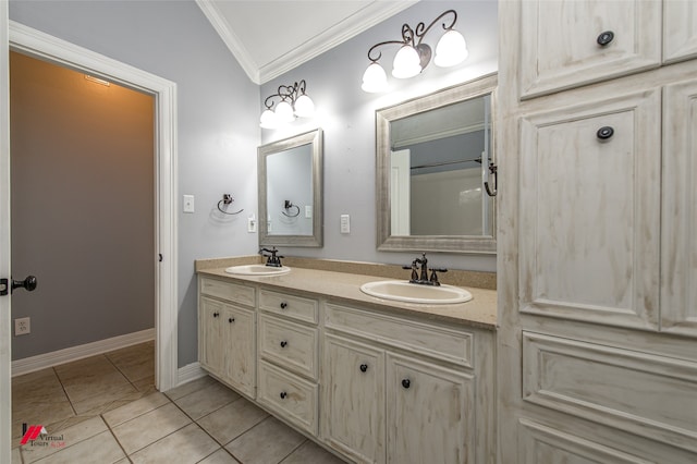 bathroom featuring lofted ceiling, tile patterned floors, ornamental molding, and vanity