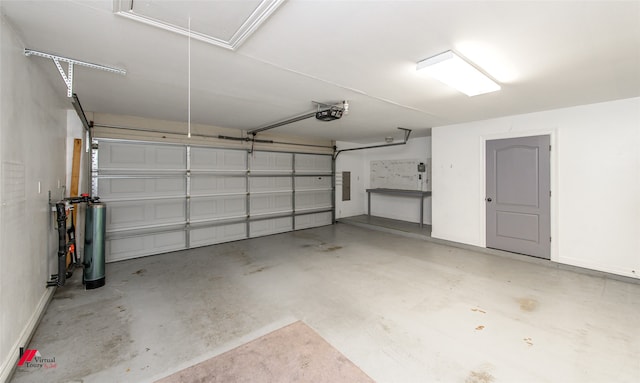 garage featuring a garage door opener and electric panel