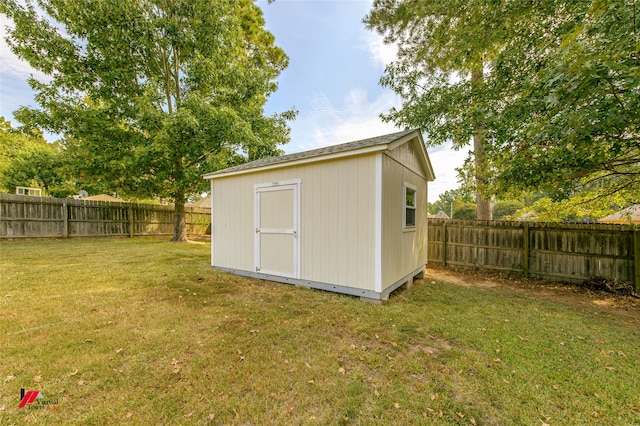 view of outbuilding with a yard