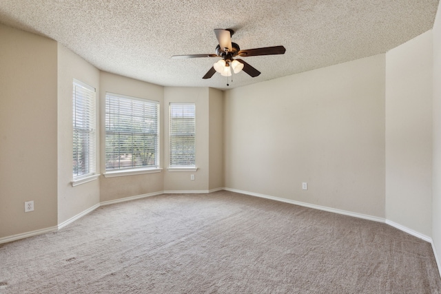 spare room with a textured ceiling, ceiling fan, and carpet flooring