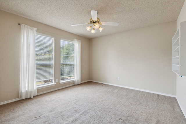 carpeted empty room featuring a textured ceiling and ceiling fan