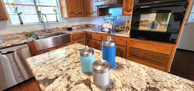 kitchen featuring light stone countertops, sink, and black appliances