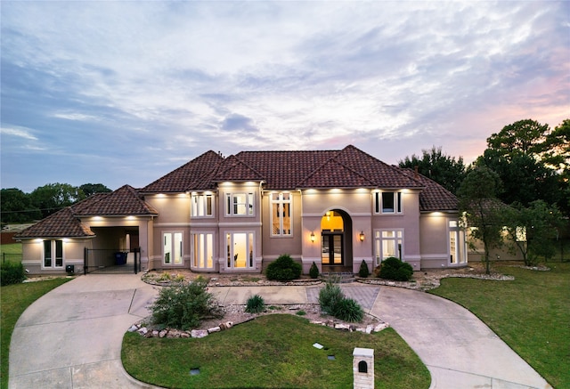 mediterranean / spanish house with french doors and a lawn