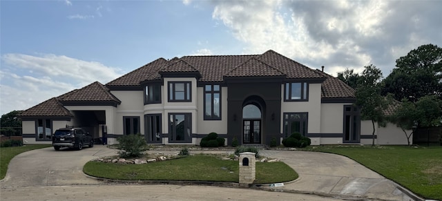 mediterranean / spanish-style home with french doors and a front lawn