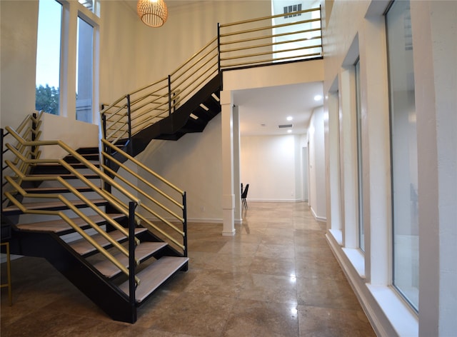 stairs featuring a high ceiling