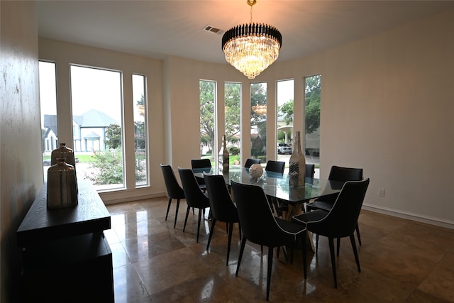 dining area featuring a notable chandelier