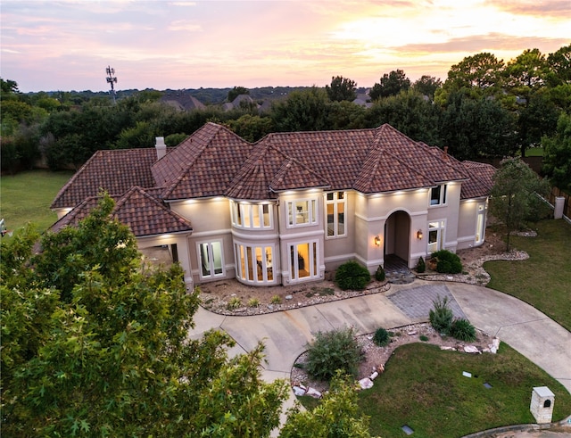 mediterranean / spanish house featuring a lawn