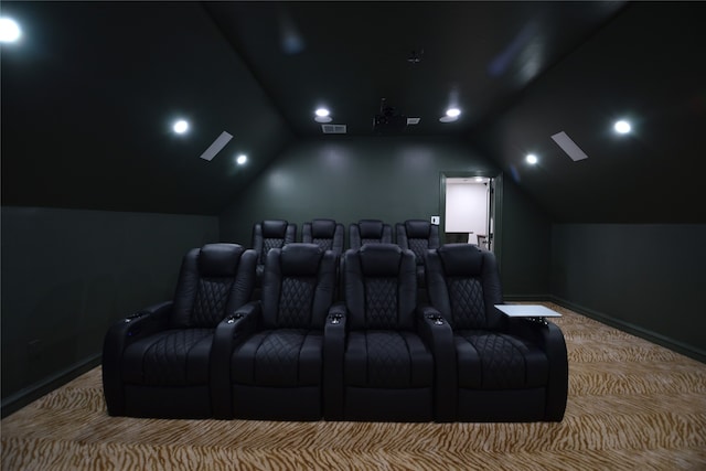 home theater room with carpet flooring and vaulted ceiling