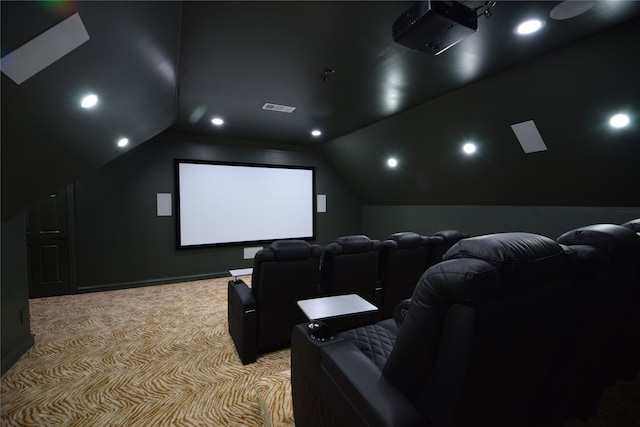 carpeted cinema room featuring lofted ceiling