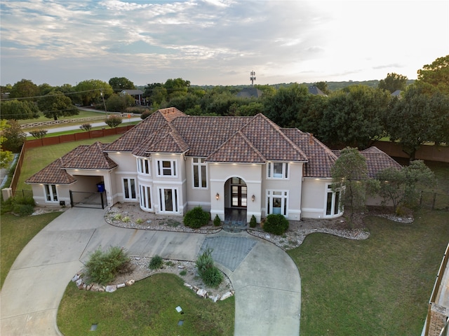 mediterranean / spanish home with a front yard