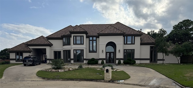 mediterranean / spanish house featuring a front lawn