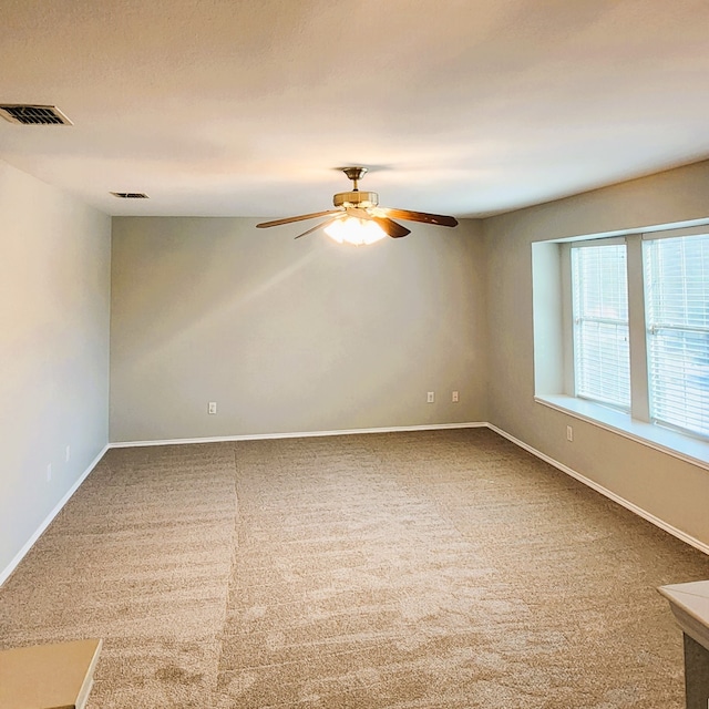 spare room featuring carpet flooring and ceiling fan