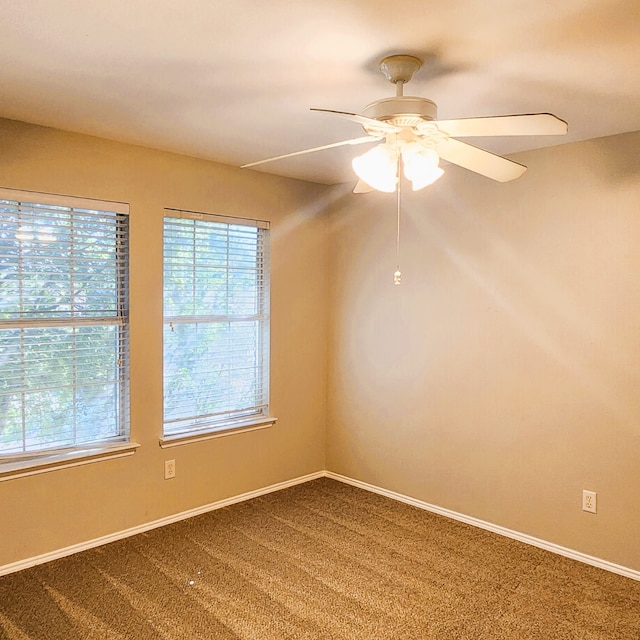 unfurnished room with ceiling fan and carpet floors