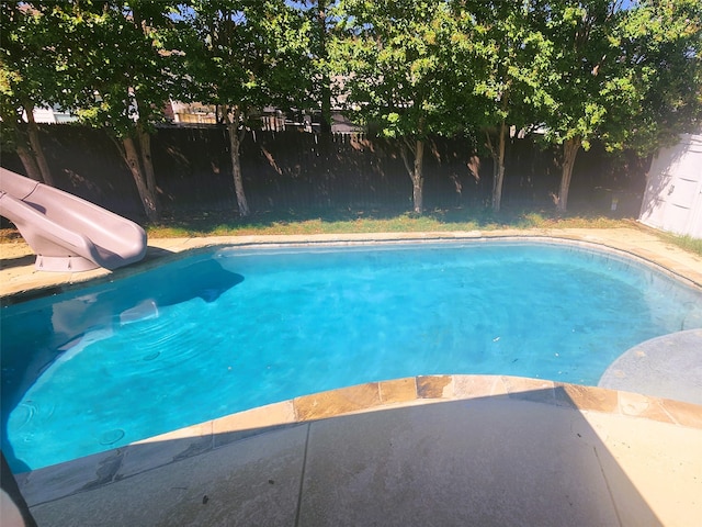 view of swimming pool with a water slide