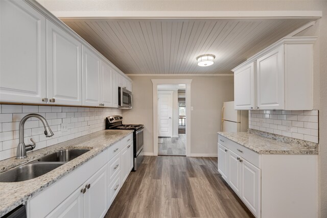 kitchen featuring dark hardwood / wood-style floors, sink, appliances with stainless steel finishes, and white cabinetry