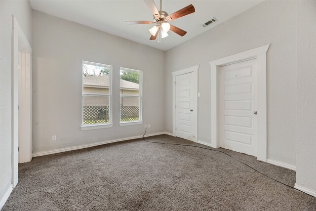 unfurnished bedroom with ceiling fan and carpet