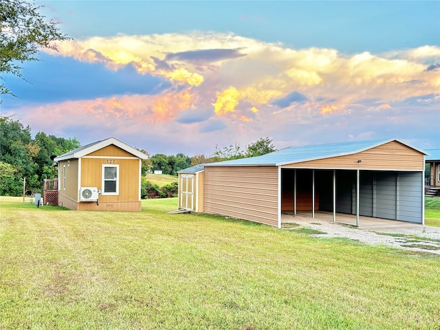 yard at dusk featuring an outdoor structure and ac unit