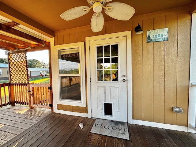 property entrance featuring a deck and ceiling fan