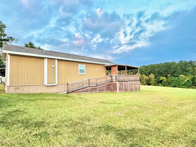 exterior space featuring a lawn and a deck